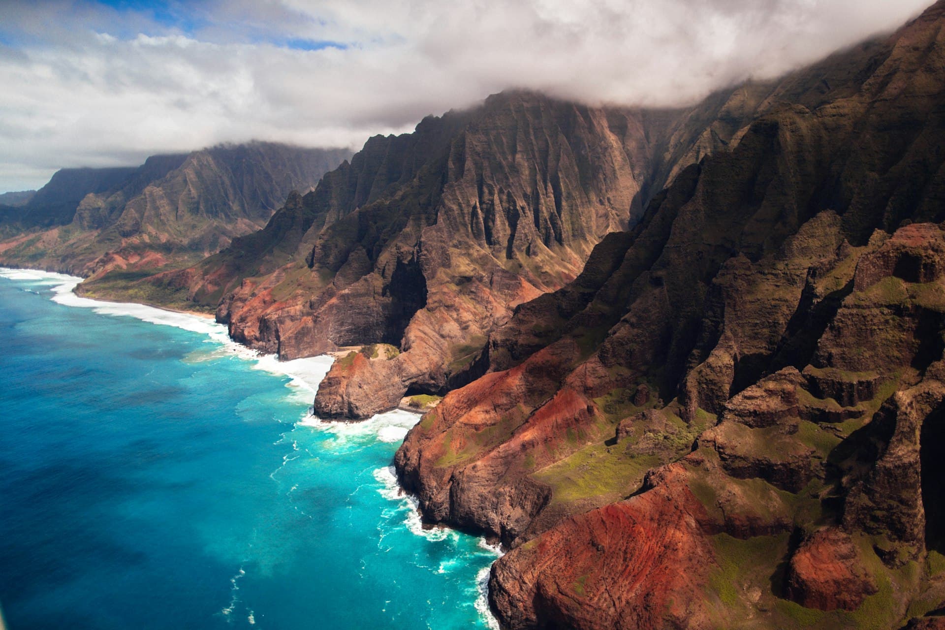 Dramatic Hawaiian coastline with emerald cliffs and turquoise ocean