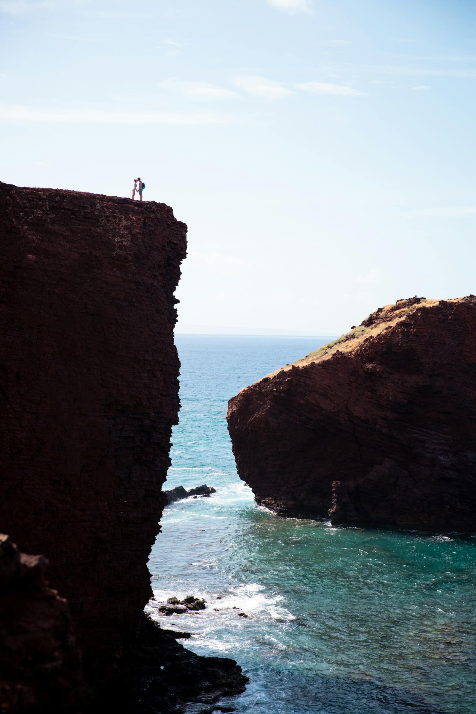 Red sea cliffs of Puʻu Pehe rising from turquoise water on Lāna'i